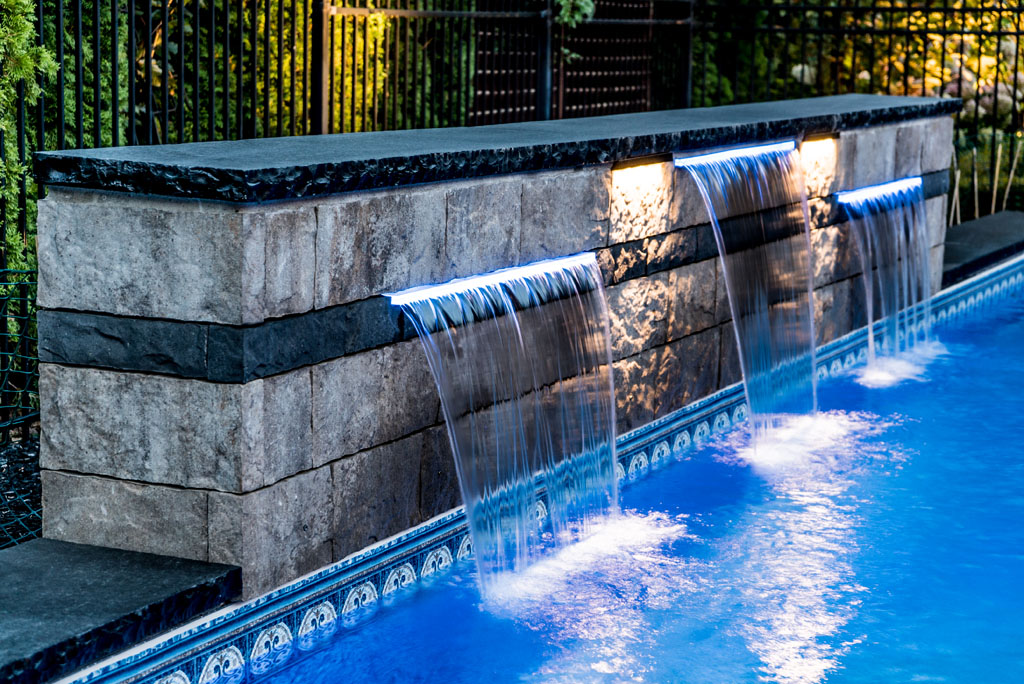 Pool and spa with dramatic lighting and waterfall